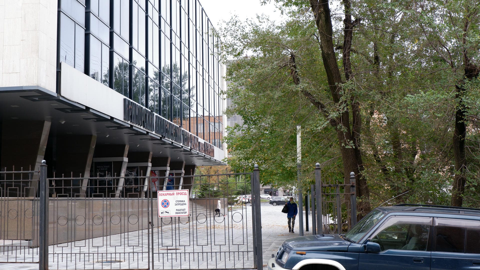 A person descending stairs while another stands at the bottom.