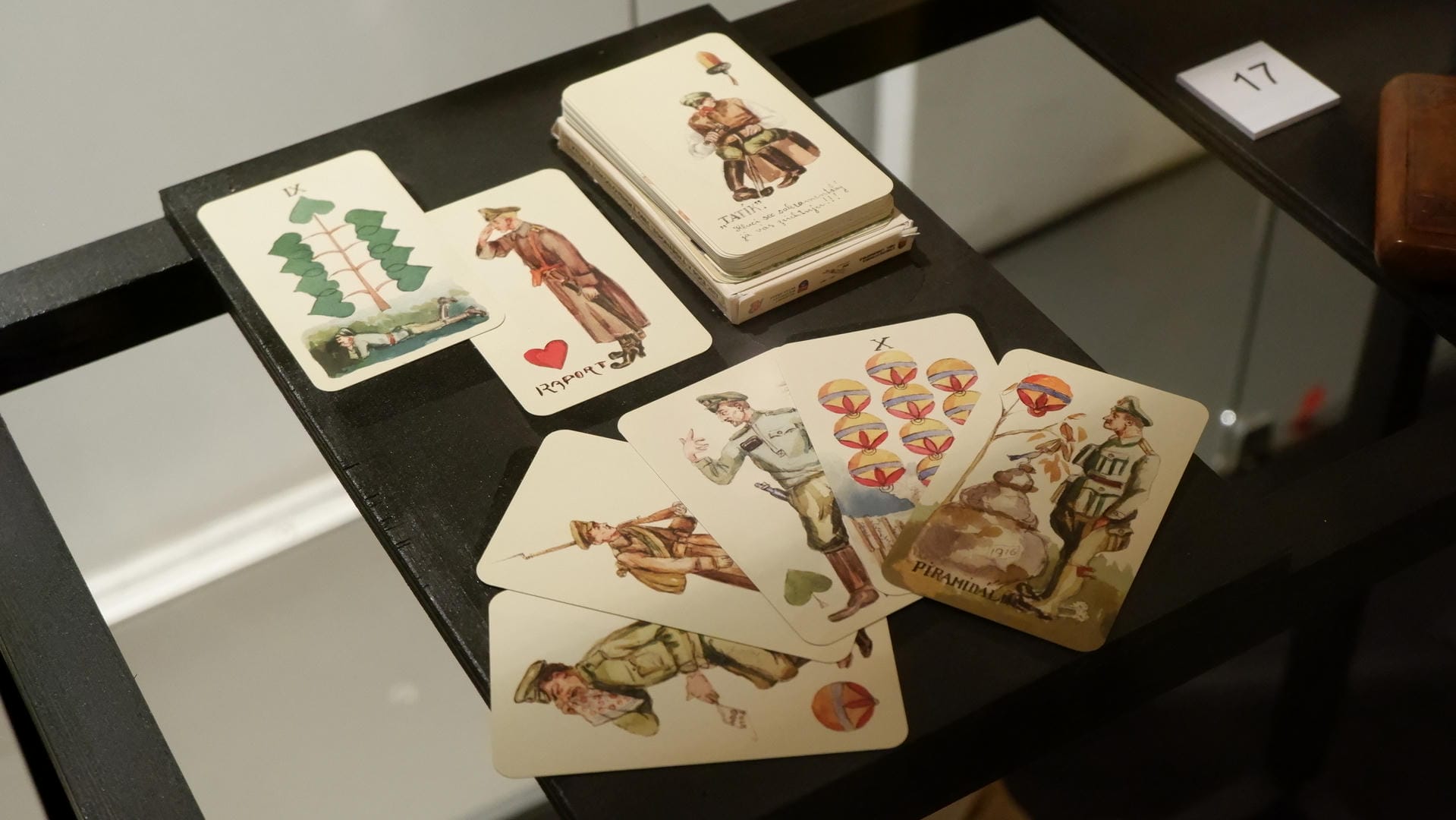 A deck of playing cards depicting soldiers scattered on a table.