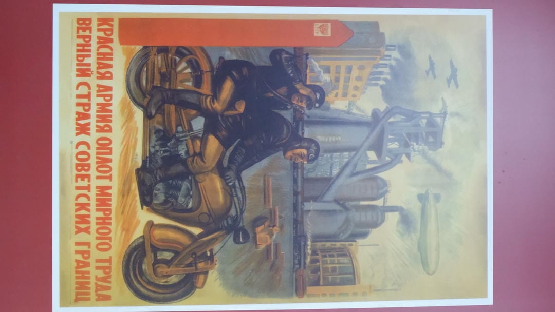 A poster showing two soldiers riding motorcycles, with industrial facilities in the background, planes and airships above.