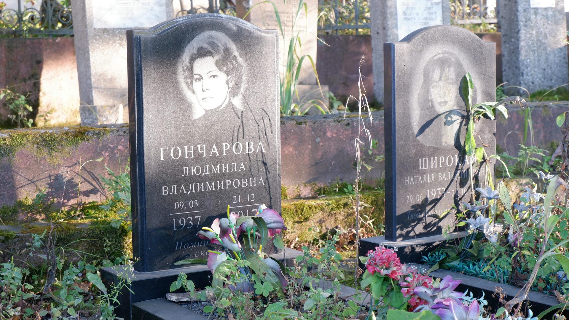 The tombstone is engraved with a female portrait, surrounded by flowers.