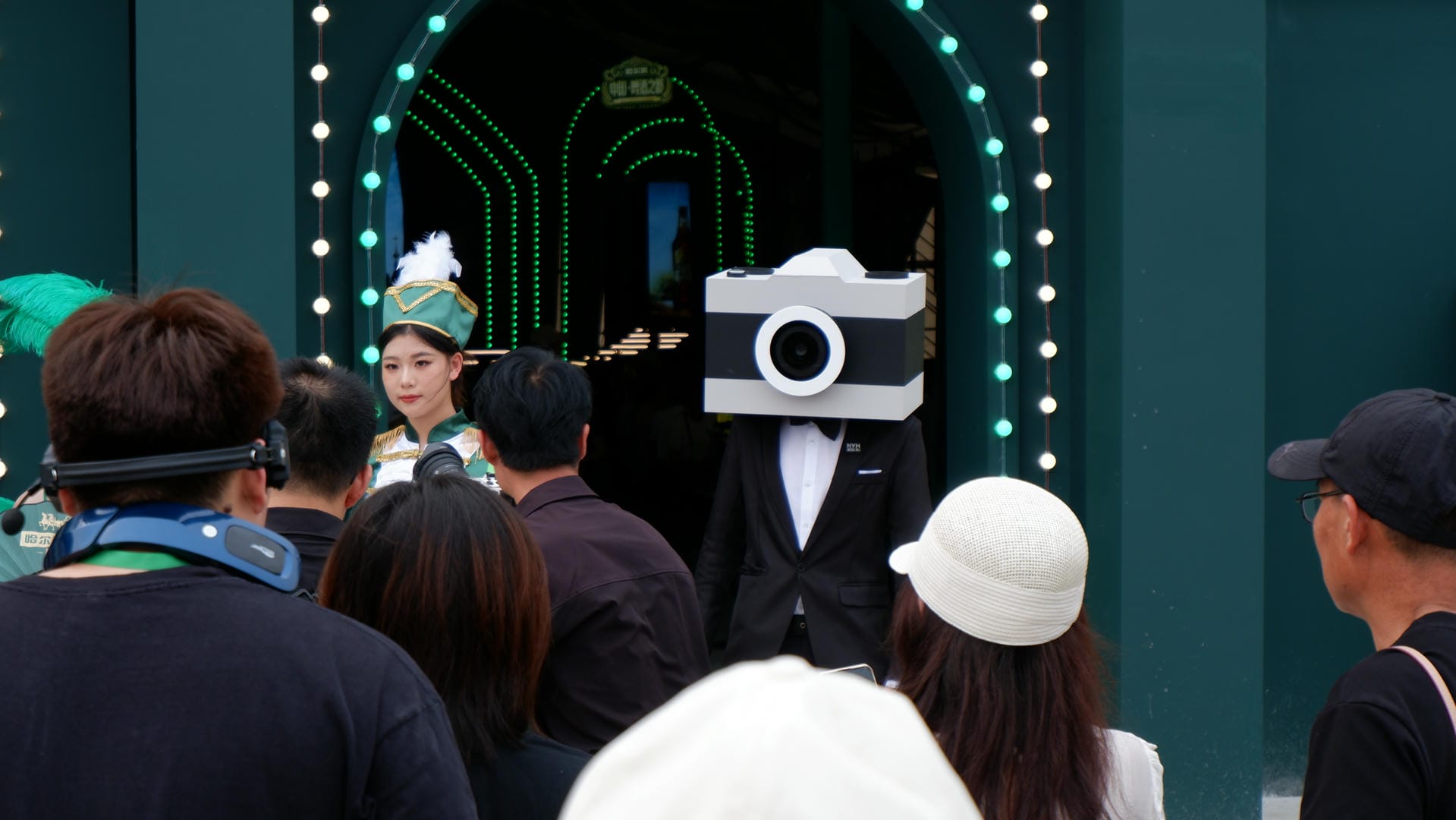 there is a man in a suit and hat with a camera on his head