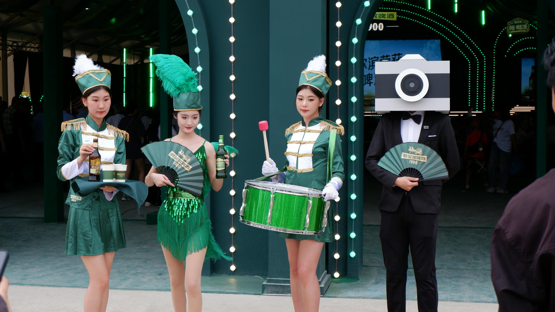 there are three girls in green costumes with a camera and a camera