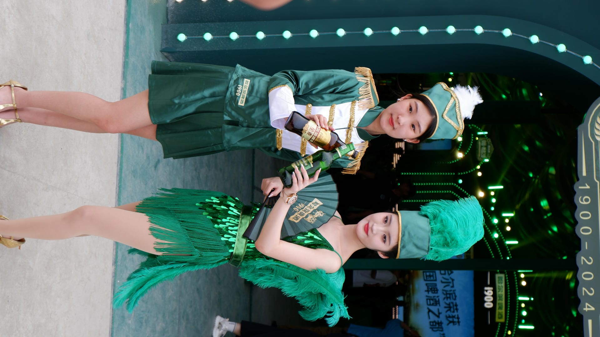 two women in green costumes standing next to each other