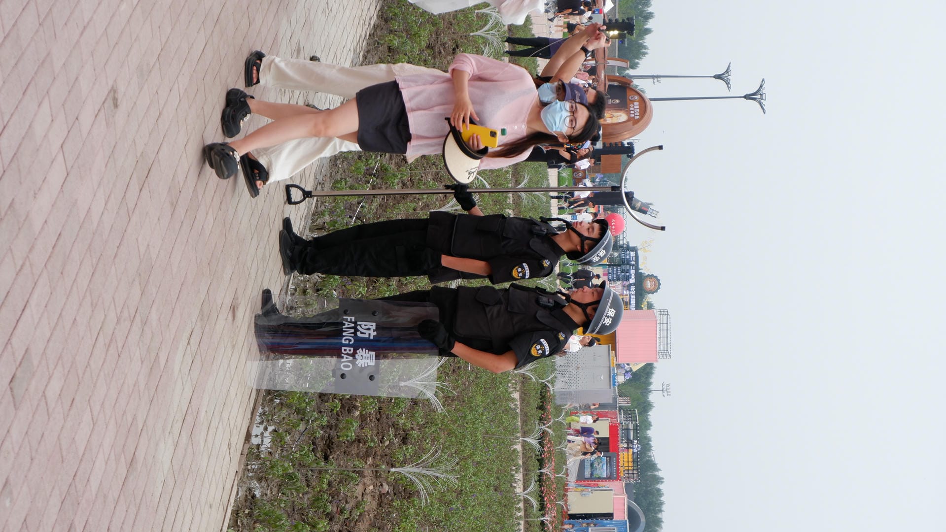 several police officers standing around a woman with a hat