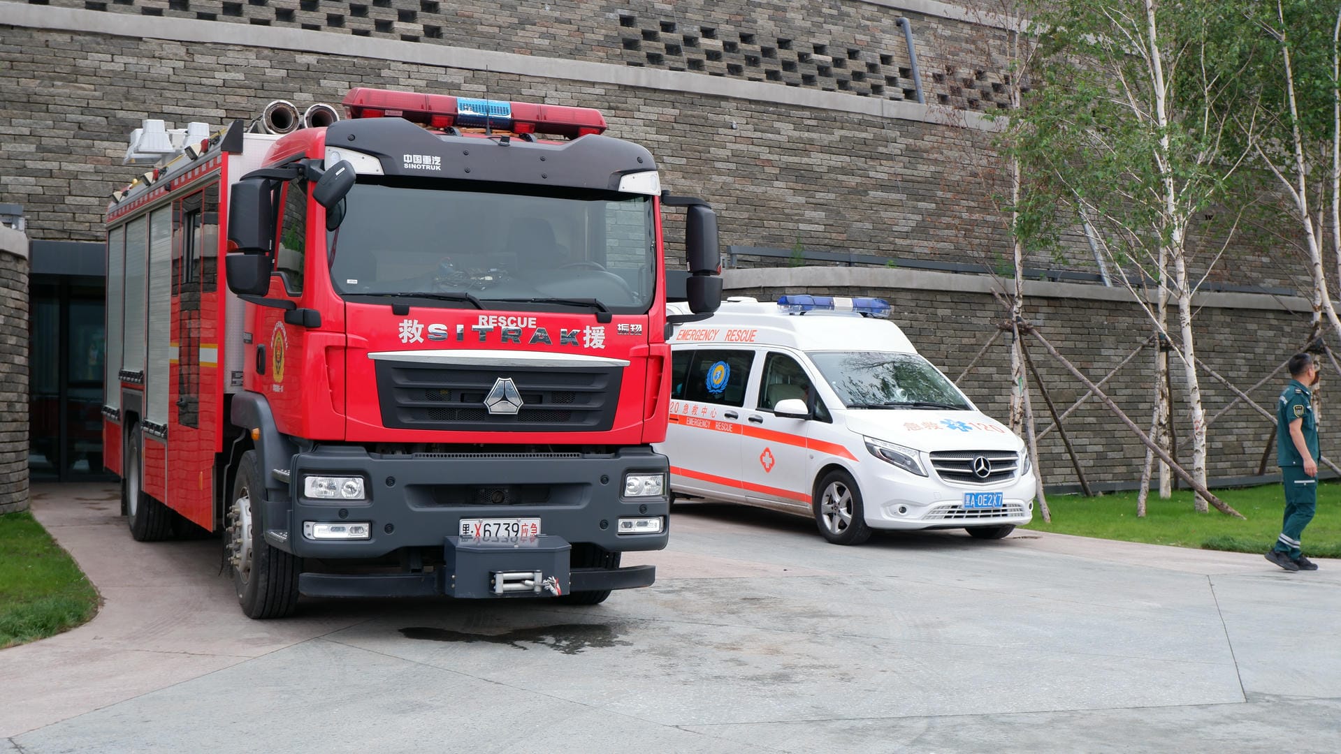 there is a red fire truck parked next to a white van