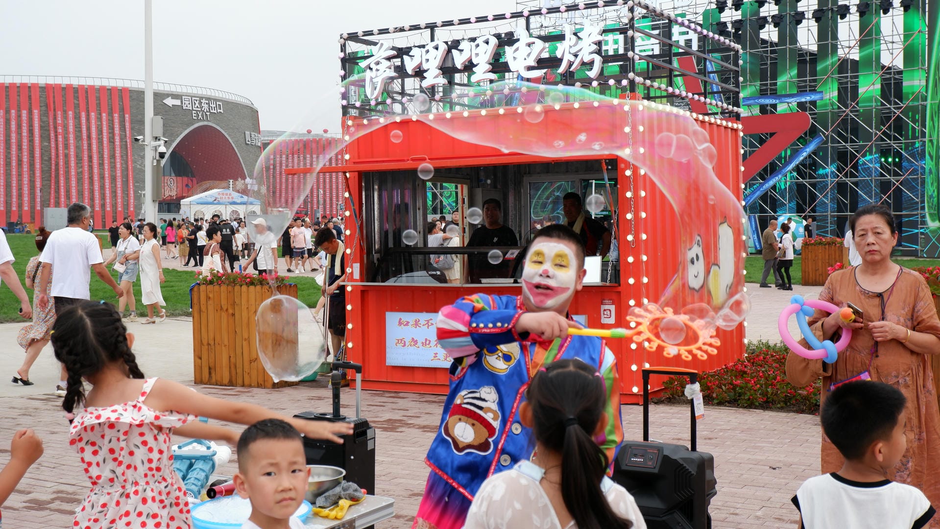 people are standing around a food cart with clowns on it
