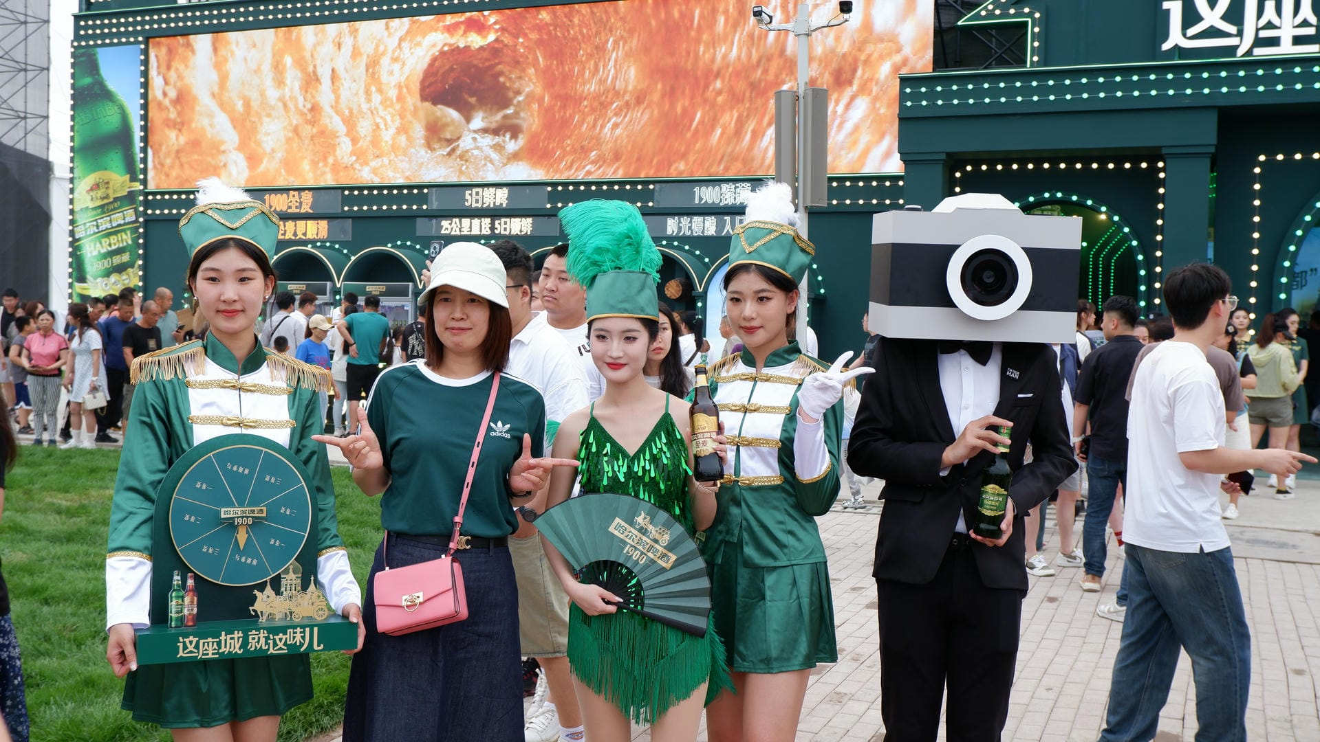 several people in green outfits are standing in a crowd