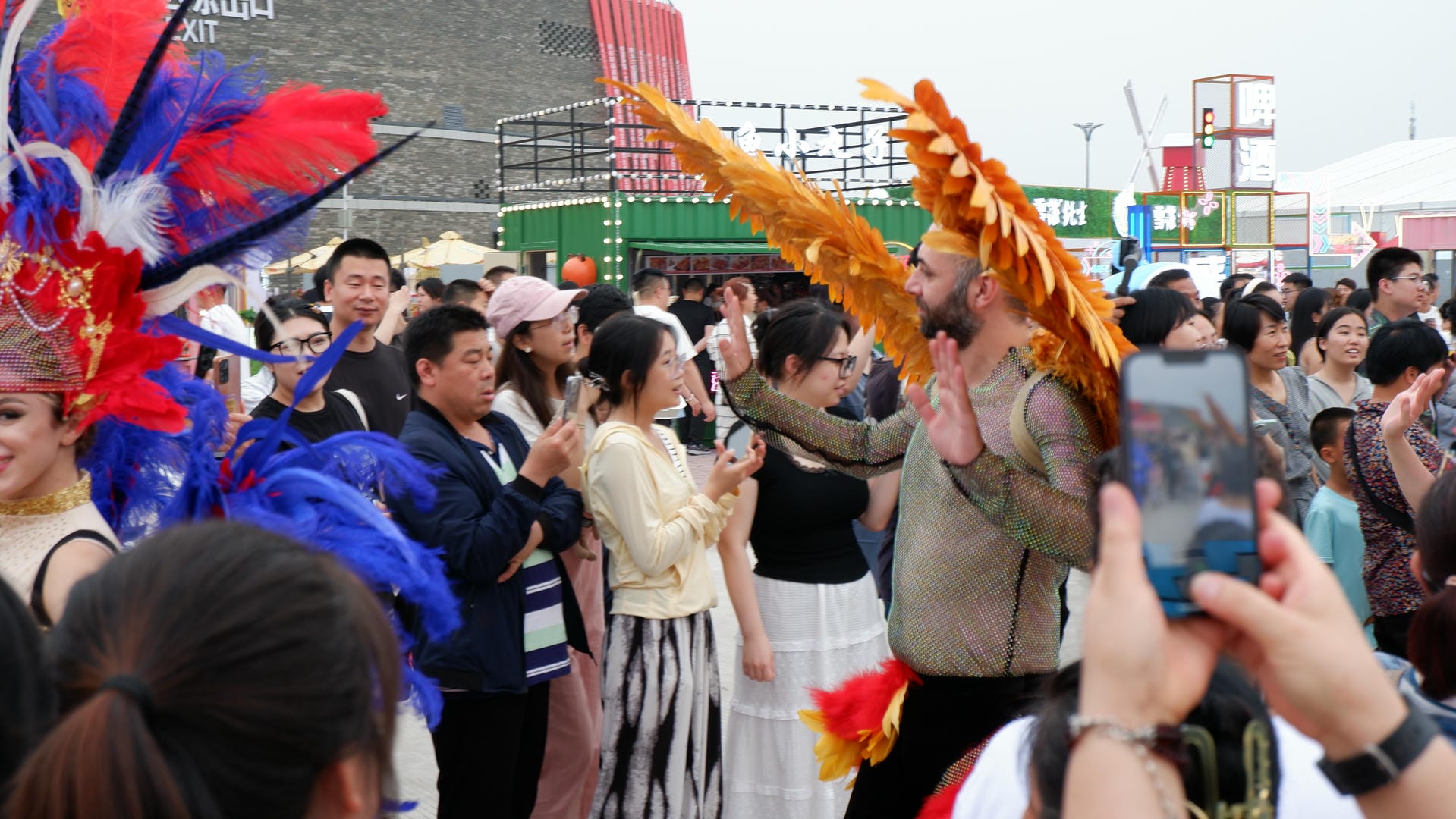people are standing in a crowd and taking pictures of a man in a costume