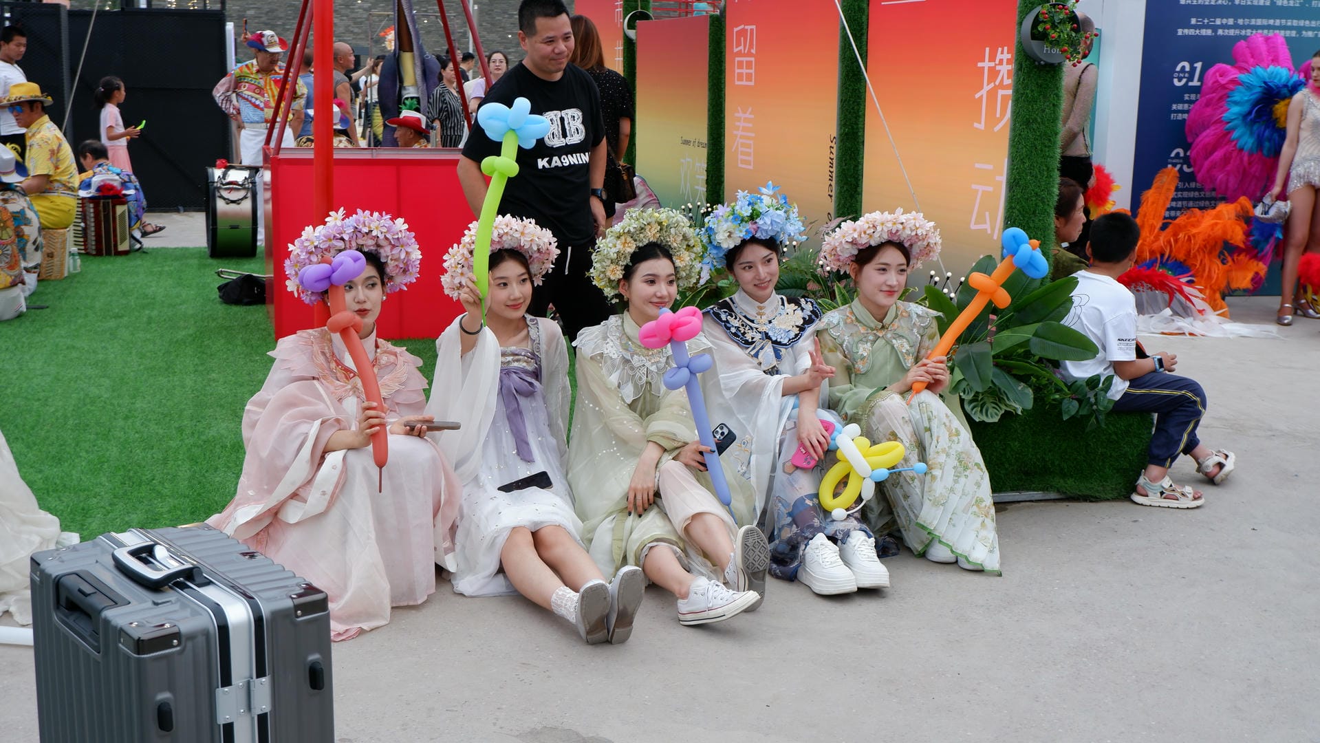several people in costumes sitting on a green grass covered field