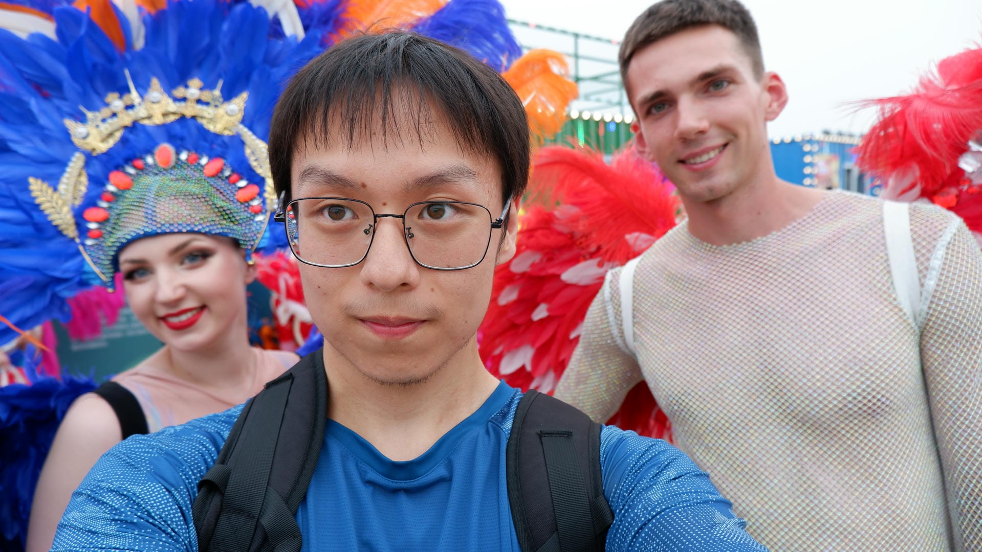 there are three people standing together in front of a colorful display