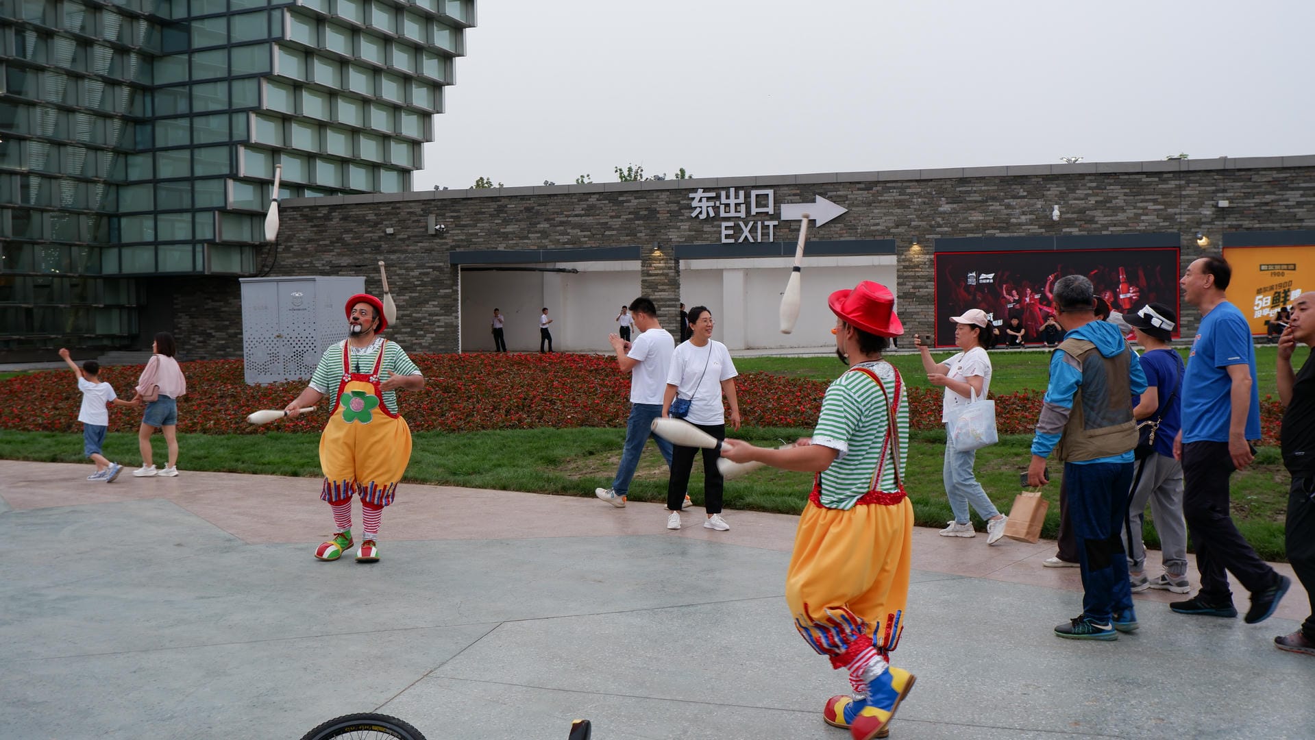 people are standing around playing with frisbees in a courtyard