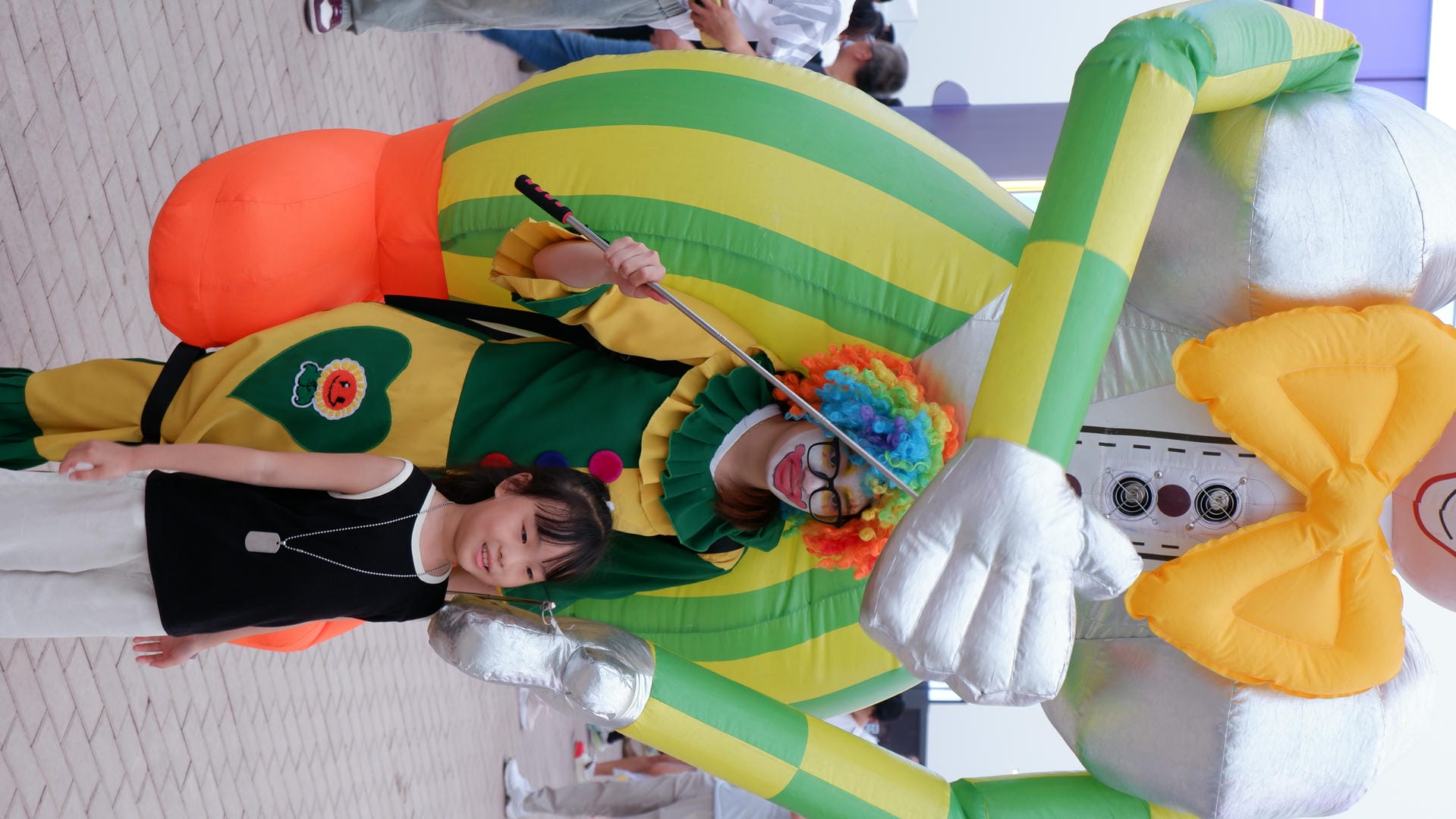 clown and child posing for a picture with giant inflatable balloon