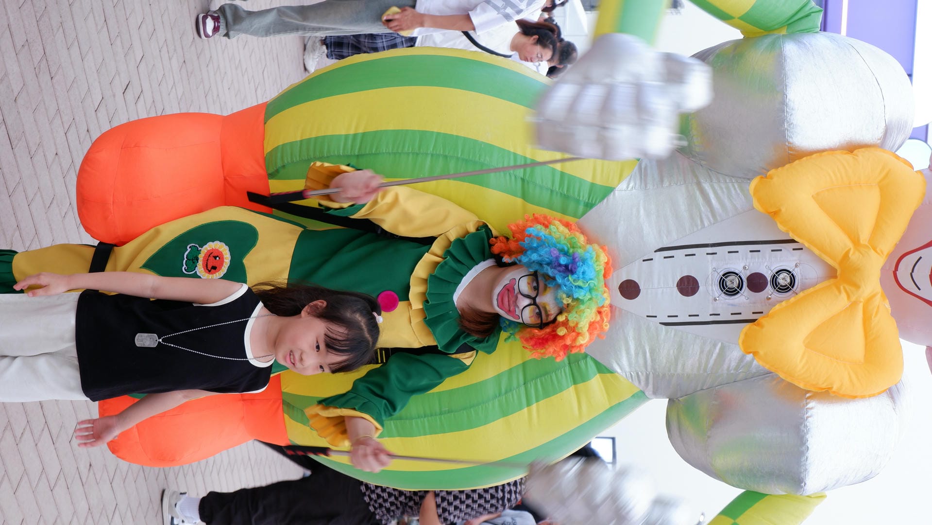 clown and girl posing for a picture in front of a giant inflatable clown