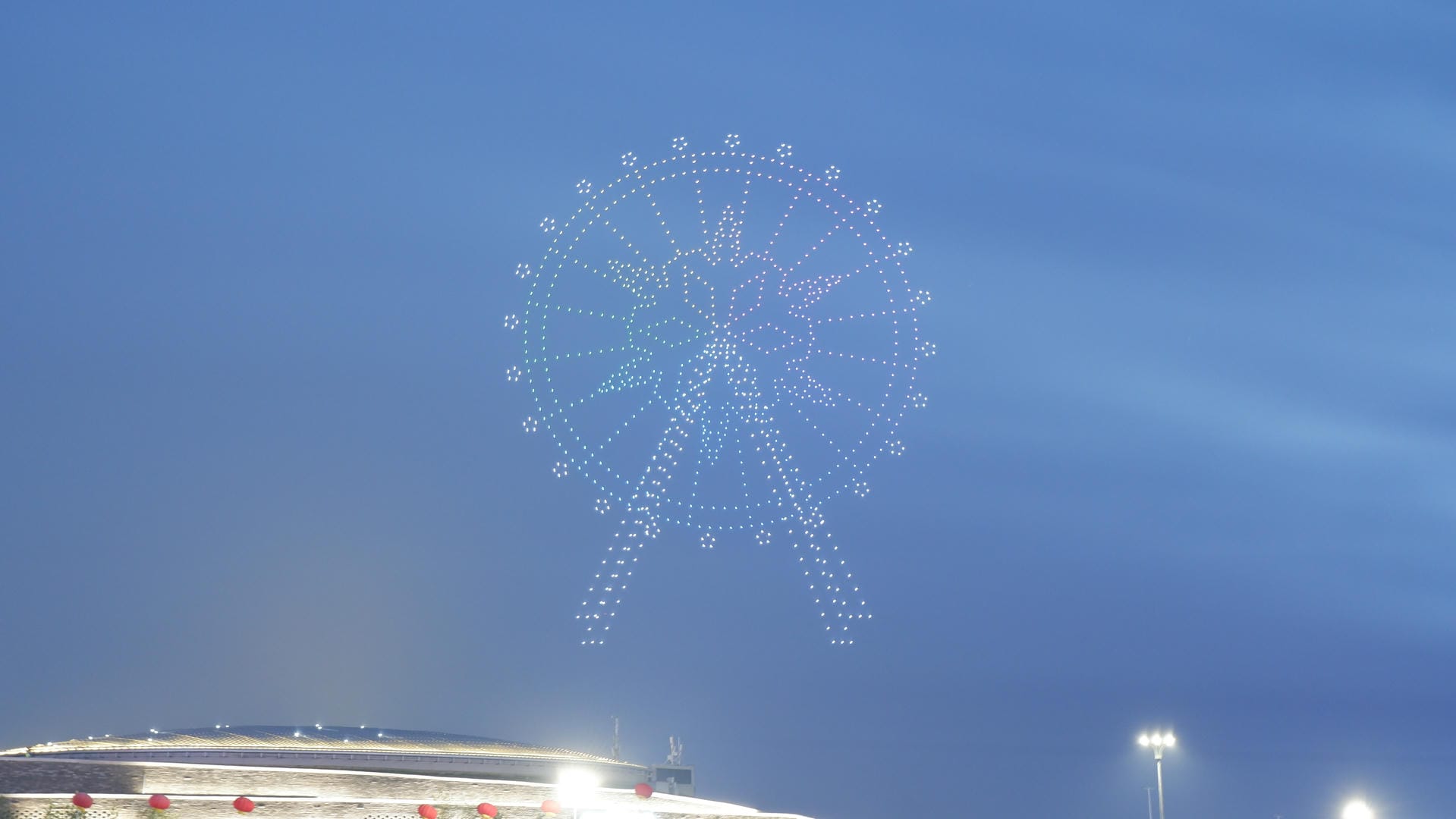 fireworks are lit up in the sky over a stadium