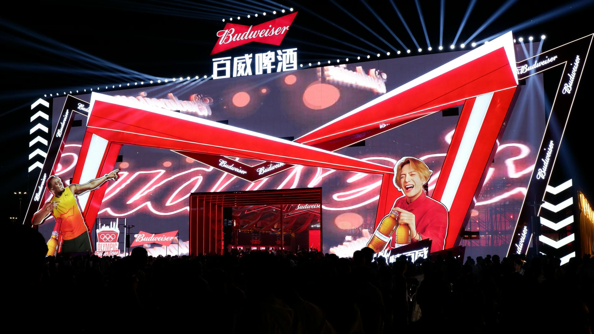 image of a man on stage with a microphone and a woman on stage