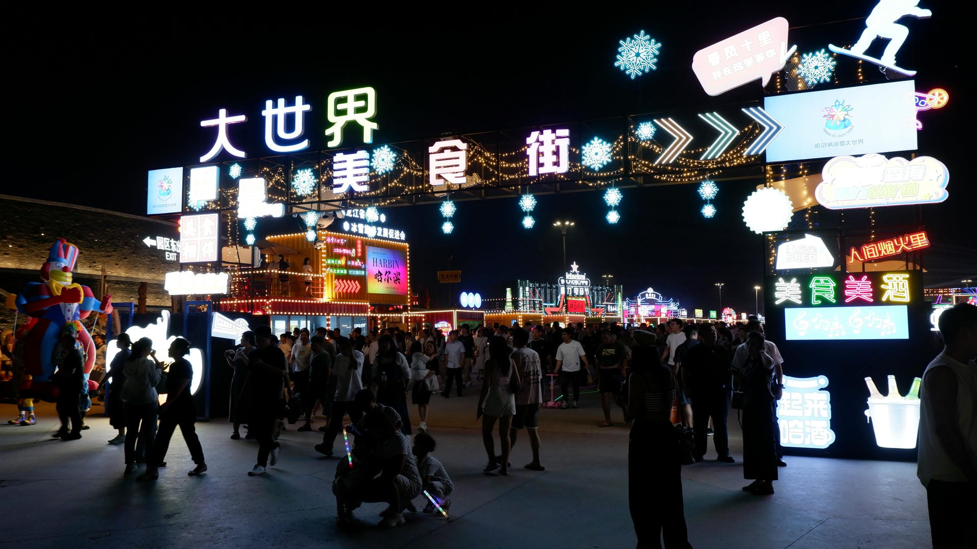 people walking around a busy street at night with many signs