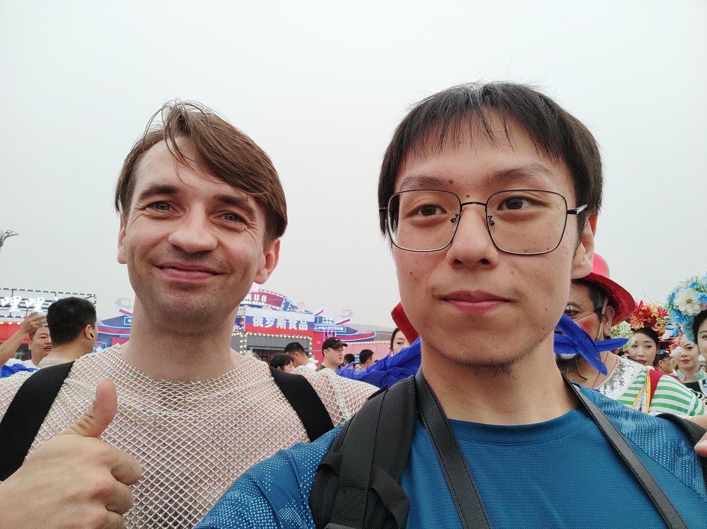 there are two men standing next to each other at a festival