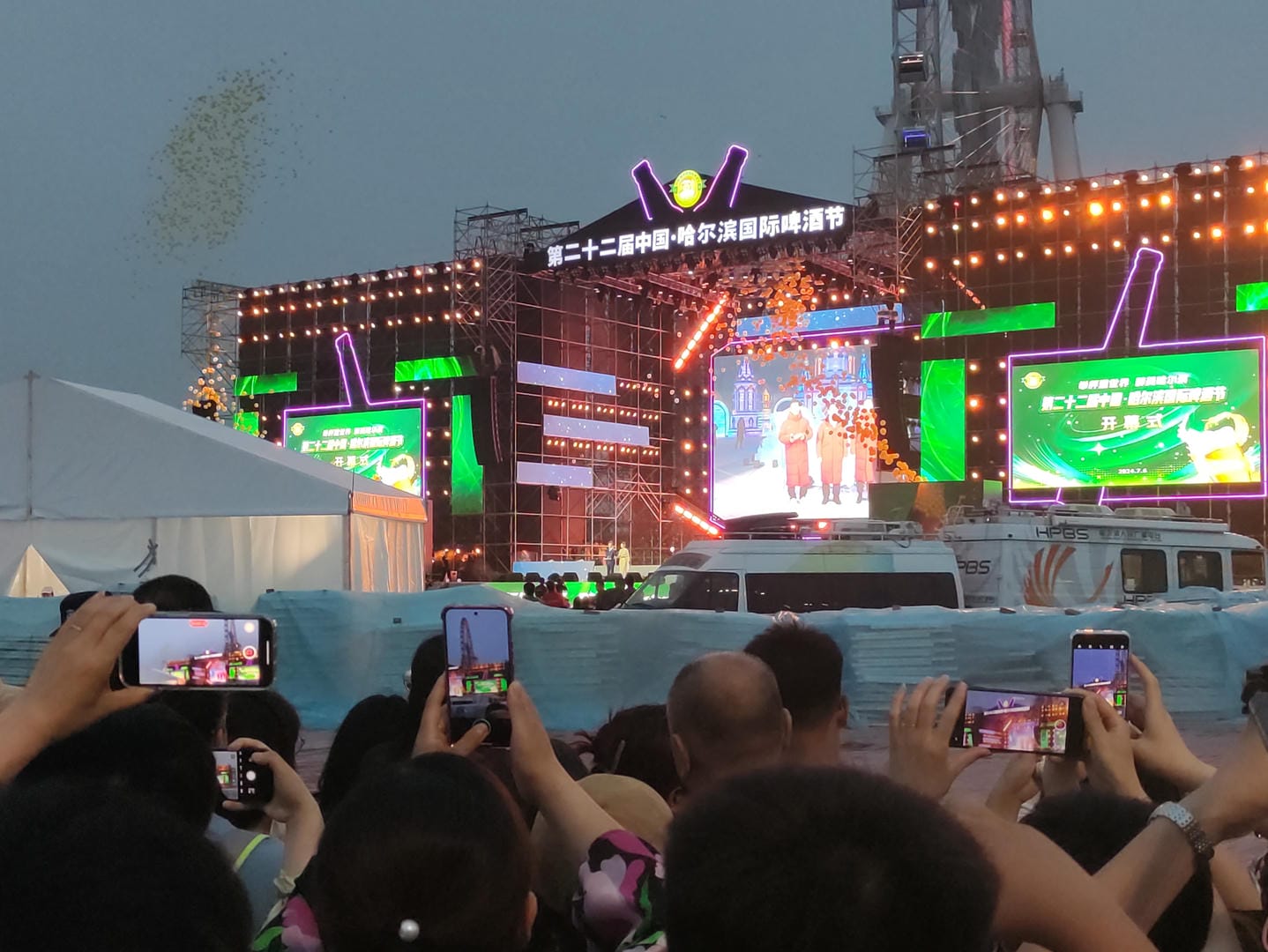 people taking pictures of a concert with their cell phones